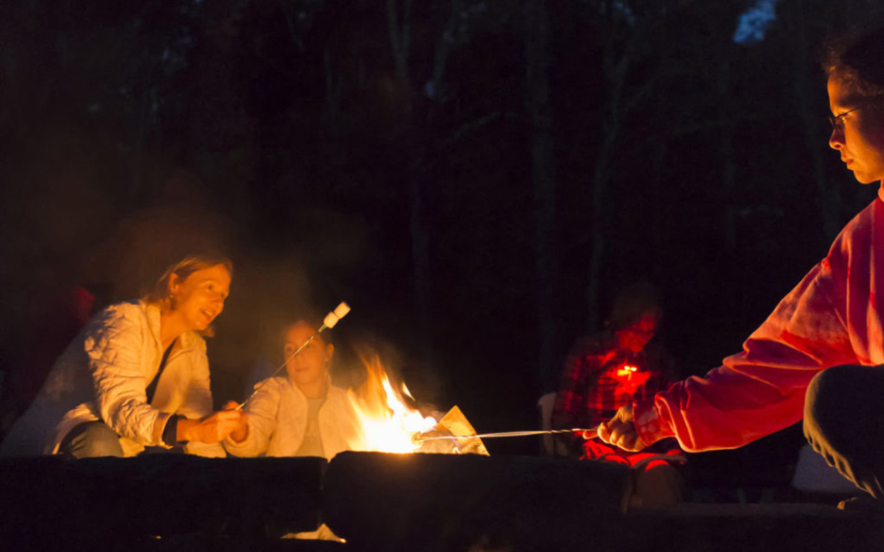 People gathering around a bonfire at Grandfather Mountain